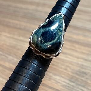 sterling silver ring with a large, teardrop-shaped moss agate
